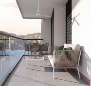 a living room with a balcony with a table and chairs at Nuruma Suites by Avia Suites in Santa Marta