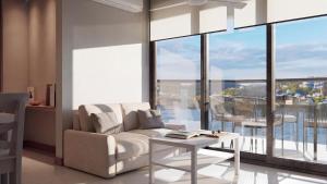 a living room with a couch and a table at Nuruma Suites by Avia Suites in Santa Marta