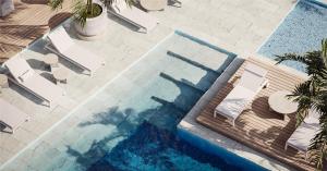 an overhead view of a swimming pool with chairs at Nuruma Suites by Avia Suites in Santa Marta