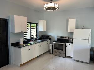 a kitchen with white cabinets and a refrigerator at 31 Runaway Meadows in Belle Air Summit