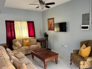a living room with two couches and a coffee table at 31 Runaway Meadows in Belle Air Summit