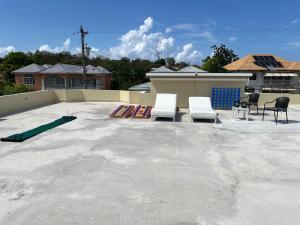 a patio with chairs and skateboards on a roof at 31 Runaway Meadows in Belle Air Summit