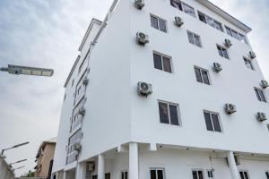 a white building with many windows at Star Hotel & Suites in Abuja