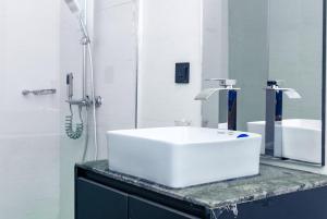 a bathroom with a white sink and a shower at Star Hotel & Suites in Abuja