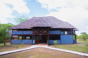 a large blue building with a thatched roof at Tembo Tarangire Lodge & Camp in Madege