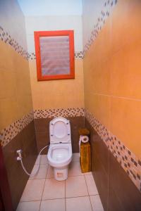 a small bathroom with a toilet and a window at Tembo Tarangire Lodge & Camp in Madege
