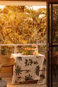 a table with a table cloth with flowers on it at Beautifully Restyled Studio Apartment - Oaks Pacific Blue - Sea Salt Escape in Salamander Bay