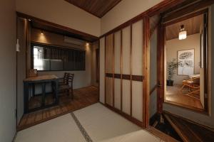 a room with a hallway with a door and a table at New Open KIKUNOYA-sora- in Nagoya