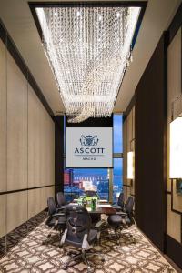 a conference room with a large chandelier and a table and chairs at Ascott Macau in Macau +41 photos