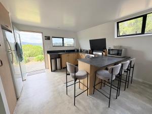 a kitchen with a table and chairs in a room at Whangaroa Barn in Whangaroa
