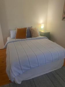 a large white bed in a room with at Birchmoore Studio in Penola