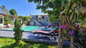 a pool with two lounge chairs and a table at Samati Hill - Pool Villa H2- Klong Ning Beach in Ko Lanta Yai