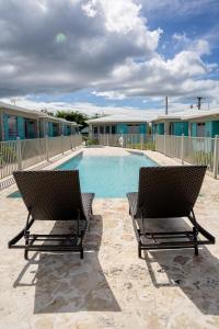 two chairs sitting in front of a swimming pool at Villa Lua, Boqueron, Puerto Rico in Cabo Rojo