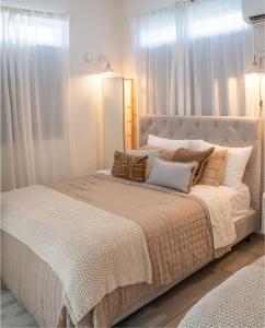 a white bedroom with a large bed with pillows at Villa Lua, Boqueron, Puerto Rico in Cabo Rojo +13 photos