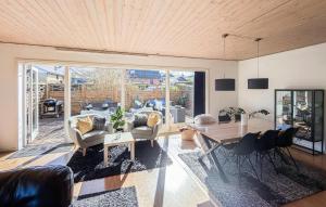 a large living room with a table and chairs at 4 Bedroom Cozy Home In Allinge in Allinge