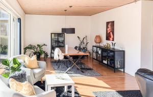 a living room with white walls and a table at 4 Bedroom Cozy Home In Allinge in Allinge