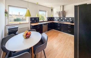 a kitchen with a table with a bowl of fruit on it at 4 Bedroom Cozy Home In Allinge in Allinge