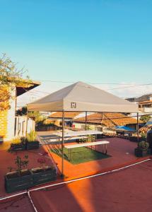 a large white tent with a picnic table under it at 13 Cielos Hostel & Coworking in San Cristóbal de Las Casas +64 photos