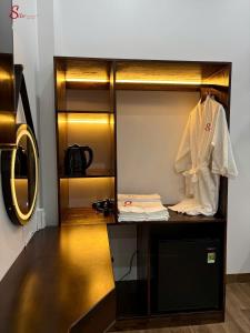 a dressing room with a white robe on a dummy at New Sitơ Hotel in Quảng Ngãi