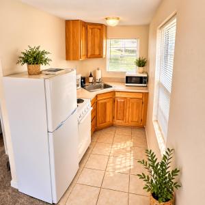 a kitchen with a white refrigerator and a sink at Buccaneer Bay Bungalow #8 in Sunrise Beach +7 photos