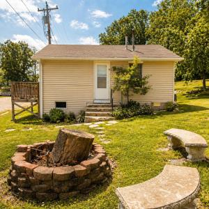 a house with a tree stump in front of it at Buccaneer Bay Bungalow #8 in Sunrise Beach