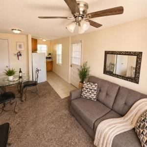 a living room with a couch and a ceiling fan at Buccaneer Bay Bungalow #8 in Sunrise Beach