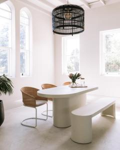 a white dining room with a white table and chairs at The Benev - Wellness Accommodation in Beechworth +17 photos