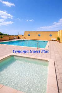 a swimming pool in front of a building at Yemanja Guest Flat- vue Mer &Salin, piscine, climatisation in Gruissan