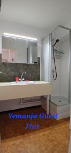 a bathroom with a sink and a shower at Yemanja Guest Flat- vue Mer &Salin, piscine, climatisation in Gruissan +8 photos