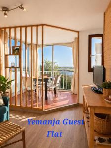 a living room with a table and a view of the ocean at Yemanja Guest Flat- vue Mer &Salin, piscine, climatisation in Gruissan