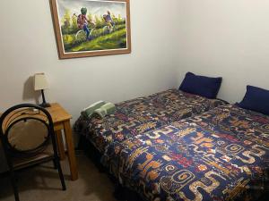 a bedroom with a bed and a picture on the wall at Highway Haven in Stilfontein