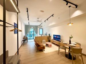 a living room with a table and a dining room at Alinea Suites by Moka in Shah Alam