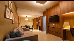 a living room with a couch and a flat screen tv at Sant copacabana in Rio de Janeiro