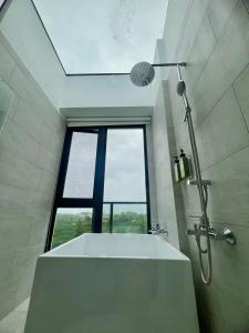 a bathroom with a tub and a large window at 有風別院民宿 登記編號3098 in Dongshan +104 photos