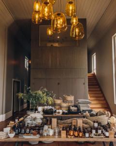 a room with a table with food and bottles on it at The Benev - Wellness Accommodation in Beechworth