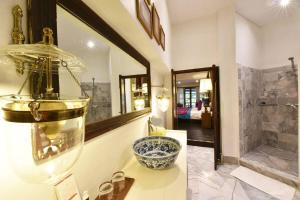 a bathroom with a glass bowl on a counter with a sink at Zantiis Ndol Villas in Muak Lek District