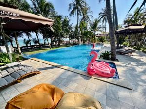 a swimming pool with a pink swan in the middle at SUNSHINE BEACH Resort in Mui Ne
