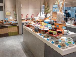 a buffet line with food on display in a restaurant at The BREAKFAST HOTEL PORTO Ishigakijima in Ishigaki Island