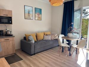 a living room with a couch and a table at Piaskowy 2 in Jantar