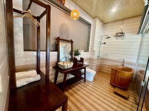 a bathroom with a tub and a sink and a mirror at Cham Trang An Retreat in Vũ Lâm +34 photos