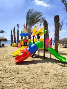 a playground on the beach near the water at Lasirena Palm Beach Sokhna Chalet in Ain Sokhna
