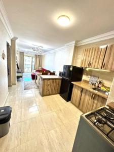 a large kitchen with wooden cabinets and a stove at Lasirena Palm Beach Sokhna Chalet in Ain Sokhna