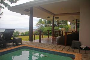 a house with a swimming pool on a deck at Baha Bar in San Juan