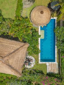 an overhead view of a swimming pool with trees at Jabeki Bungalows Bingin Beach, Uluwatu in Uluwatu