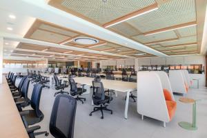 a large office with a long table and chairs at BLive Coliving Canggu in Canggu