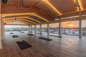a room with yoga mats on the floor of a building at BLive Coliving Canggu in Canggu
