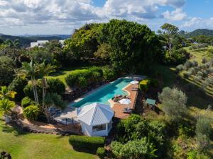 an aerial view of a resort with a pool and a house at Summergrove Estate in Carool