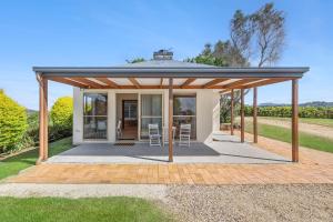 a pavilion with a table and chairs on a patio at Summergrove Estate in Carool +7 photos