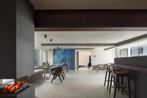 a living room with a fireplace and tables and chairs at WHITEBALANCE Hotel Dali in Dali
