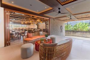 a restaurant with chairs and tables and a bar at BLive Coliving Canggu in Canggu
